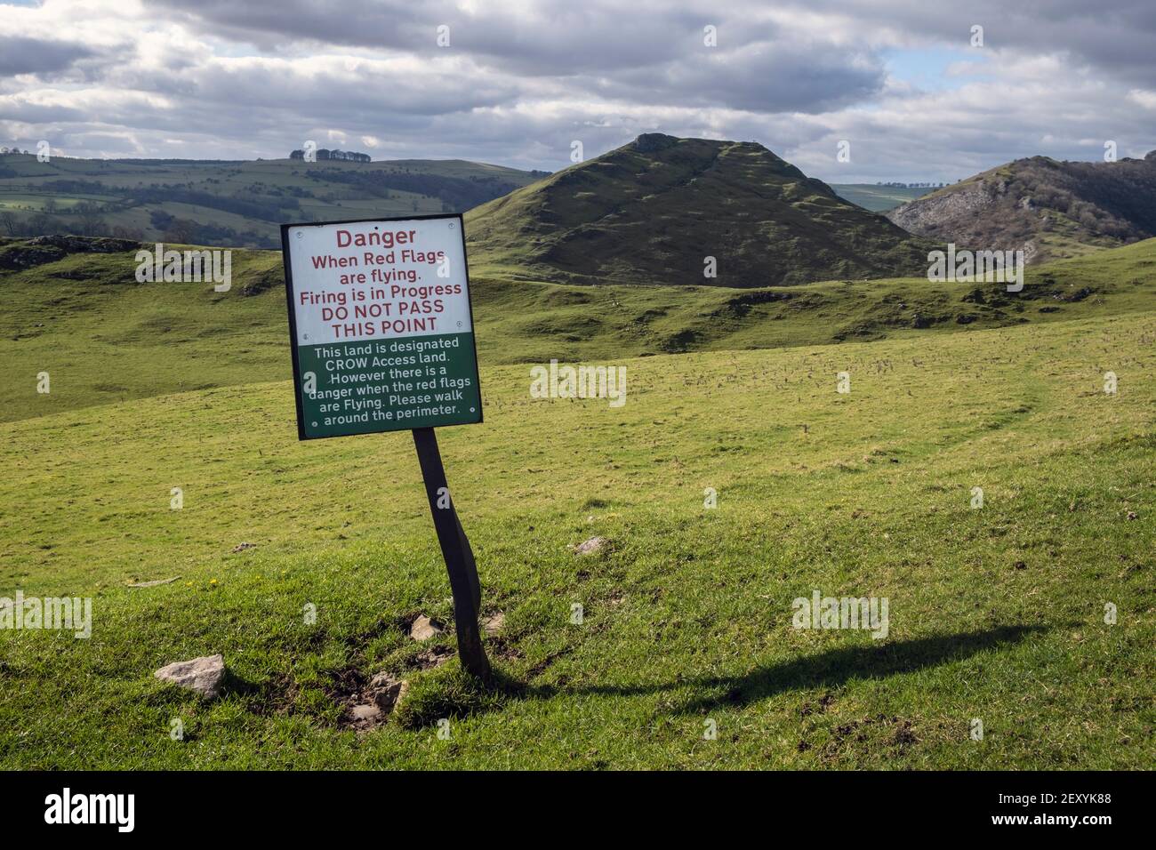 Warning sign on the edge of a rifle range at Thorpe with Thorpe Cloud in the background, Peak District National Park, Derbyshire Stock Photo