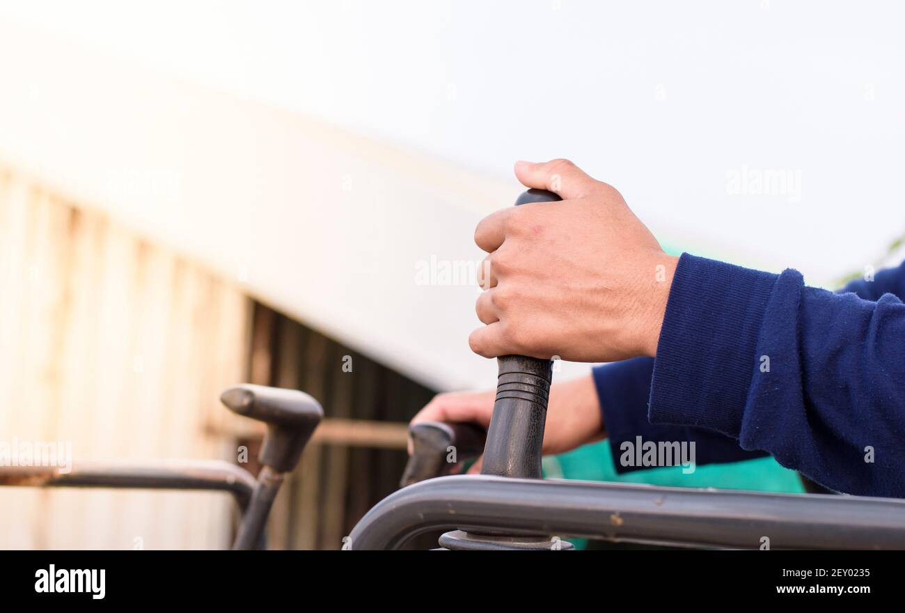 A man hand is controlling a backhoe, building contractor. Stock Photo