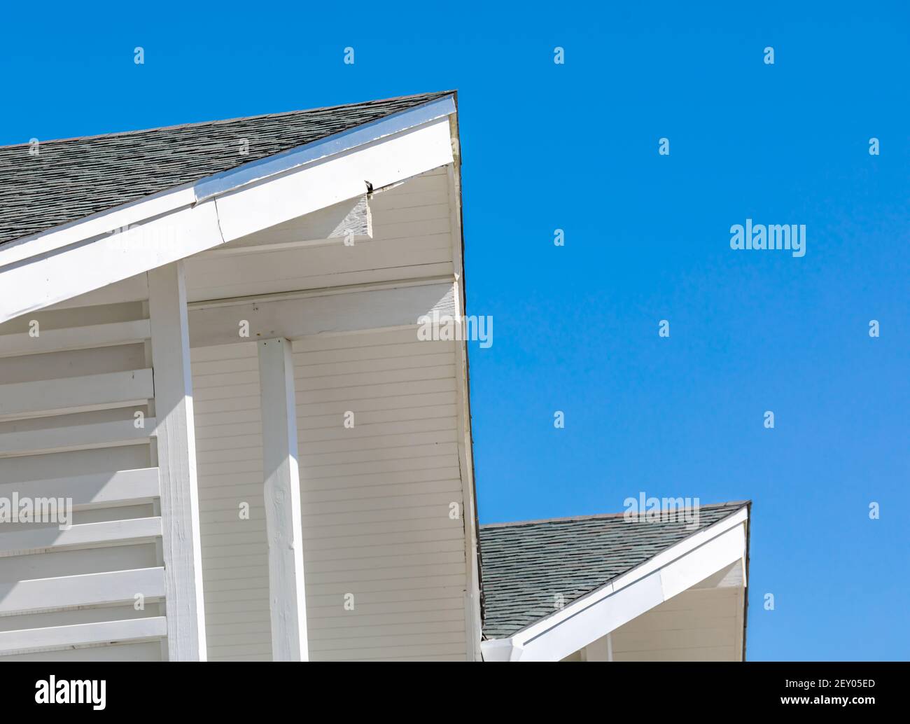 Architectural photograph of a roof against a brilliant blue sky Stock Photo