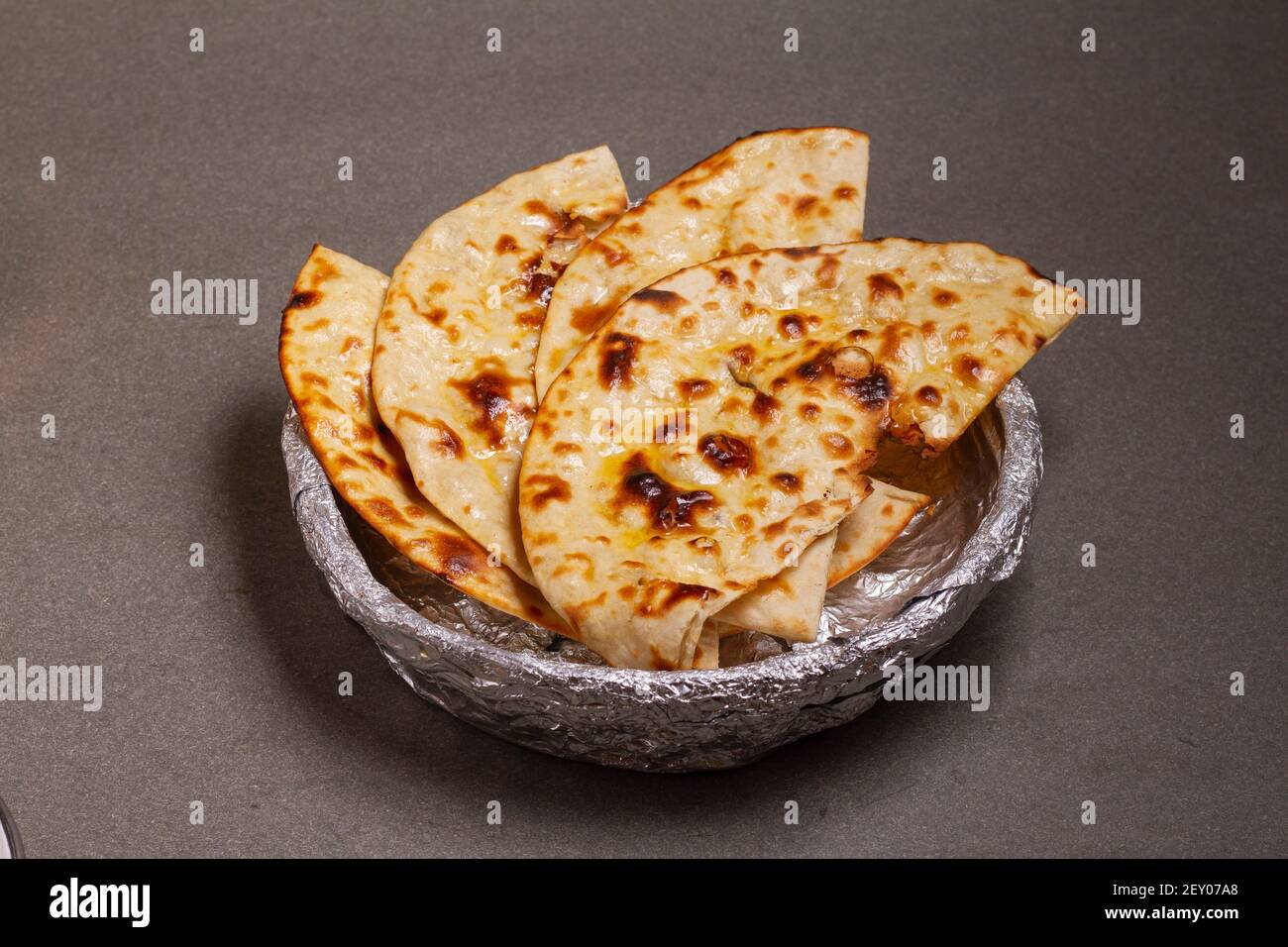 Indian cuisine Tandoori Roti also served in basket including chapati,  flatbread, naan or nan bread on wooden background Stock Photo - Alamy