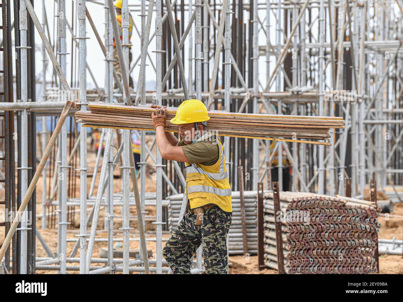 Haikou, China's Hainan Province. 5th Mar, 2021. A worker is busy at the construction site of a passenger transportation station at the Xinhai Port in Haikou, south China's Hainan Province, March 5, 2021. The completion of this project will help improve the service level of the Xinhai Port in Haikou. Credit: Pu Xiaoxu/Xinhua/Alamy Live News Stock Photo