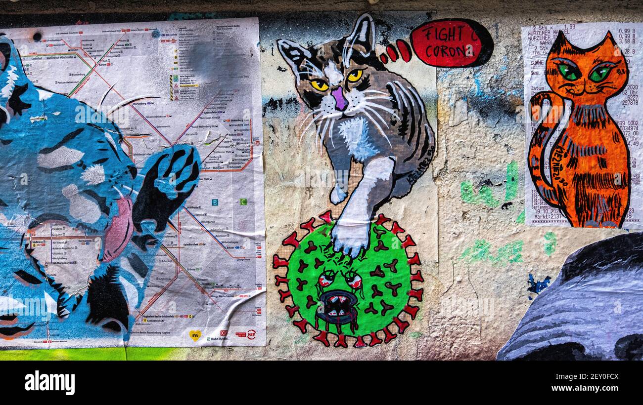 Bright little paste-ups in the inner courtyard at Haus Schwarzenburg that is  deserted during the Covidpandemic, Mitte, Berlin Stock Photo