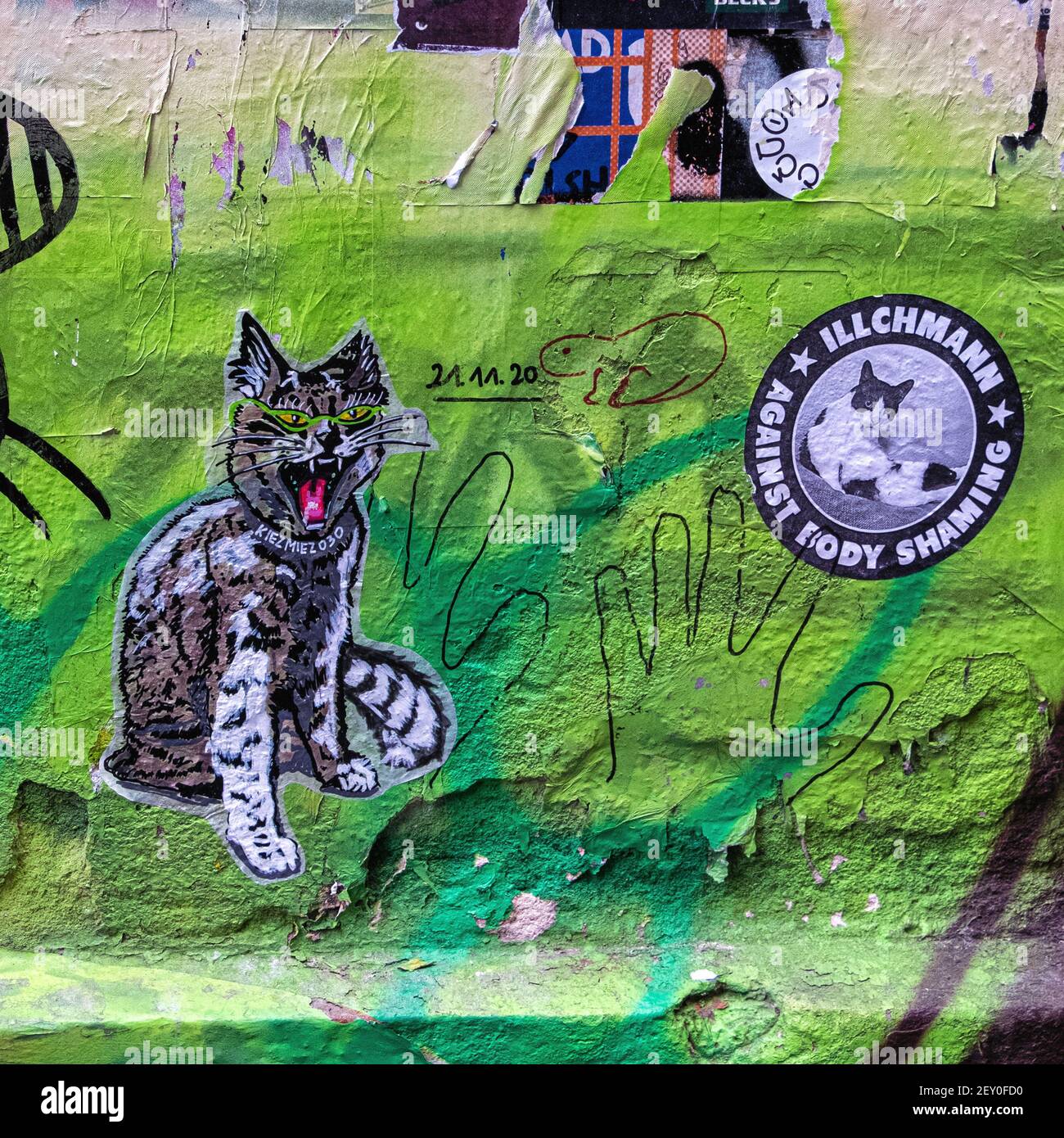 Bright little paste-ups in the inner courtyard at Haus Schwarzenburg that is  deserted during the Covidpandemic, Mitte, Berlin Stock Photo