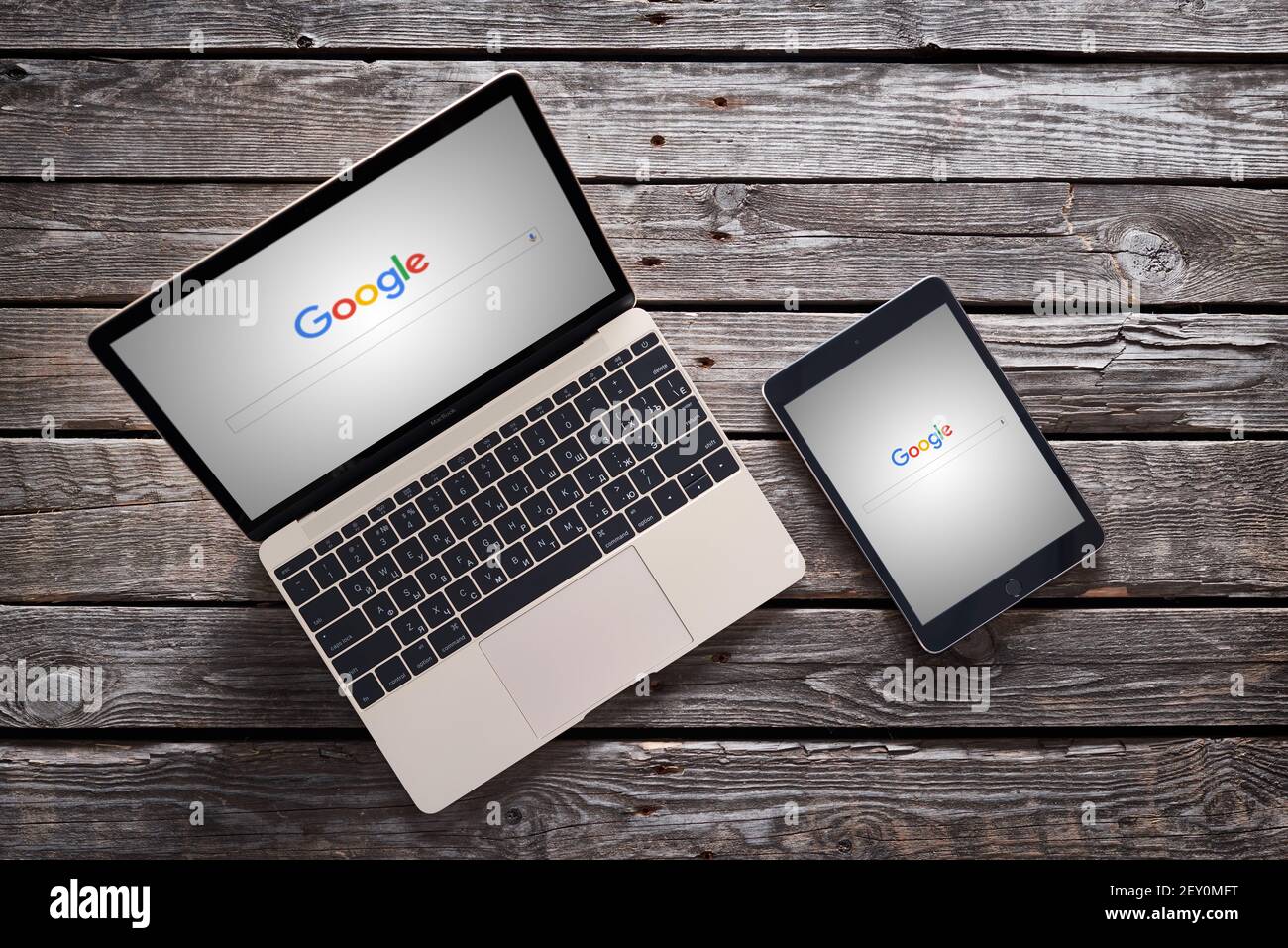 New Google logo on macbook and ipad Stock Photo