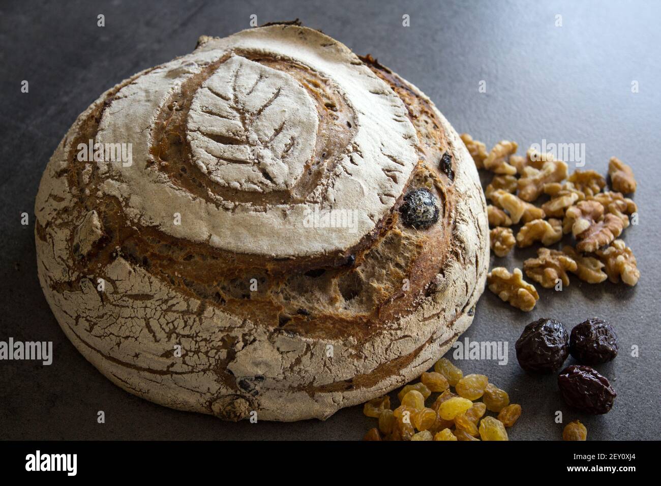 Round sourdough bread made of whole grain close up photo. Freshly backed bread texture. Healthy