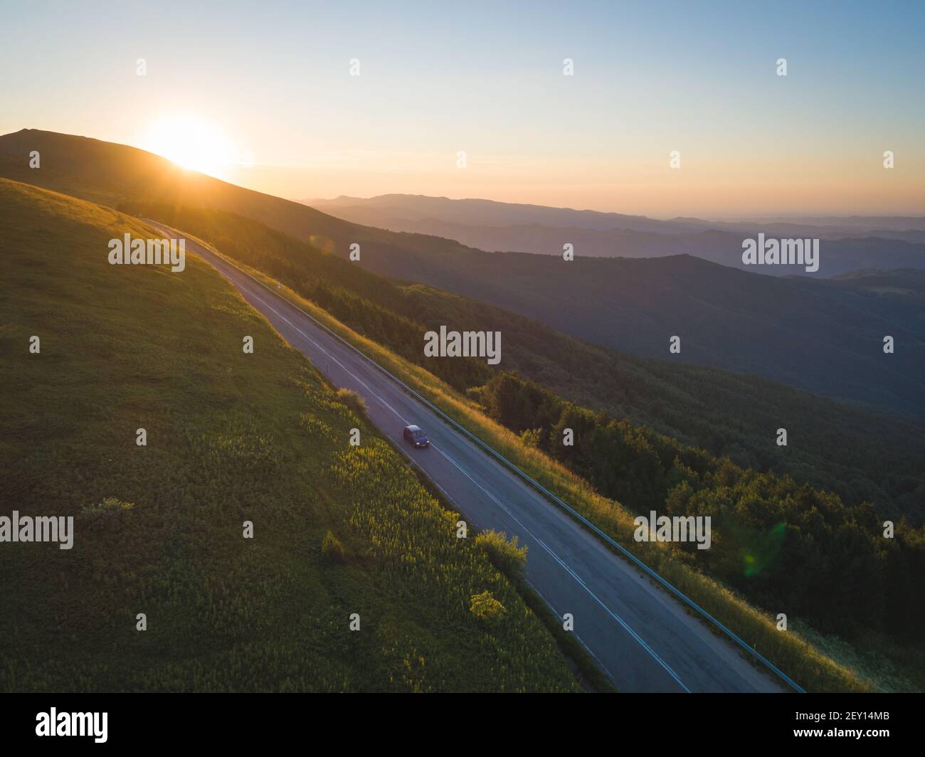Traveler with car in the mountain road at sunset Stock Photo - Alamy