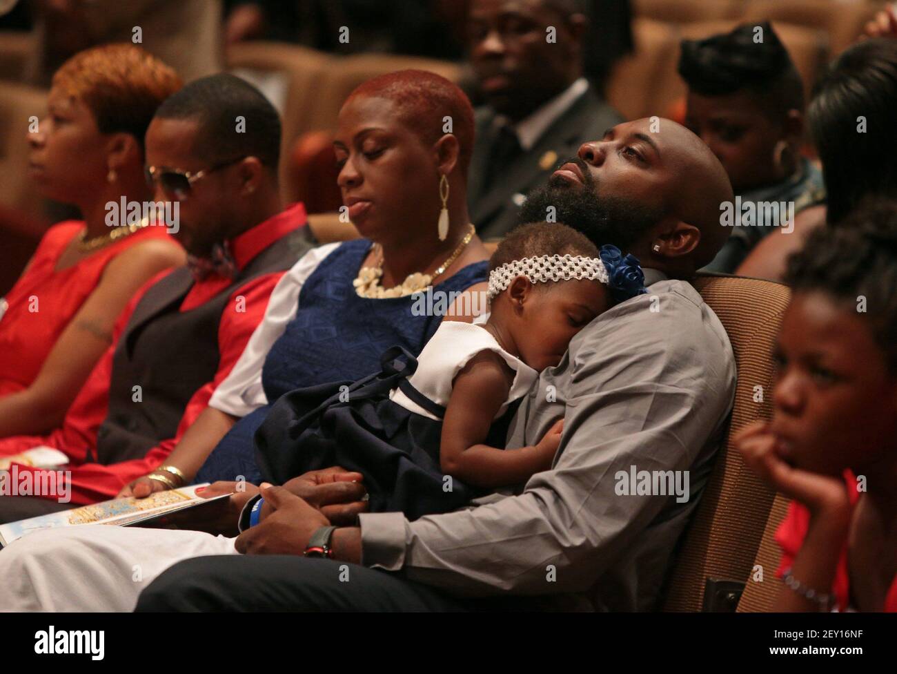 Michael Brown Sr. sits with an unidentified girl on his lap during the funeral services for his son Michael Brown on Monday, Aug. 25, 2014, at Friendly Temple Missionary Baptist Church in St. Louis. Also pictured are, from left: Lesley McSpadden, Michael Brown's mother; Louis Head, Michael Brown's stepfather; and Cal Brown, Michael Brown's stepmother. (Photo by Robert Cohen/St. Louis Post-Dispatch/MCT/Sipa USA) Stock Photo