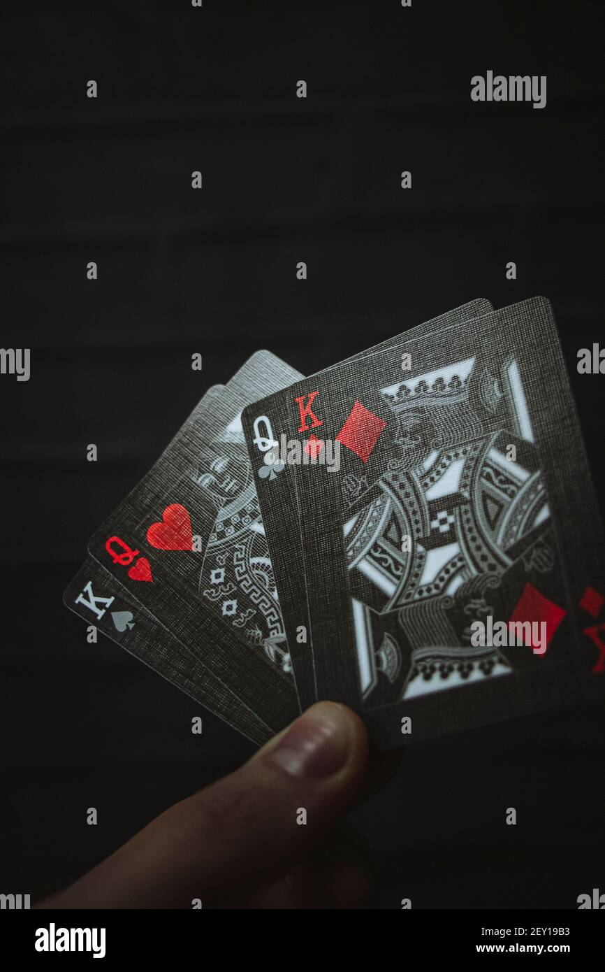 A dark set of Playing cards, shot in a dark natural backdrop Stock Photo