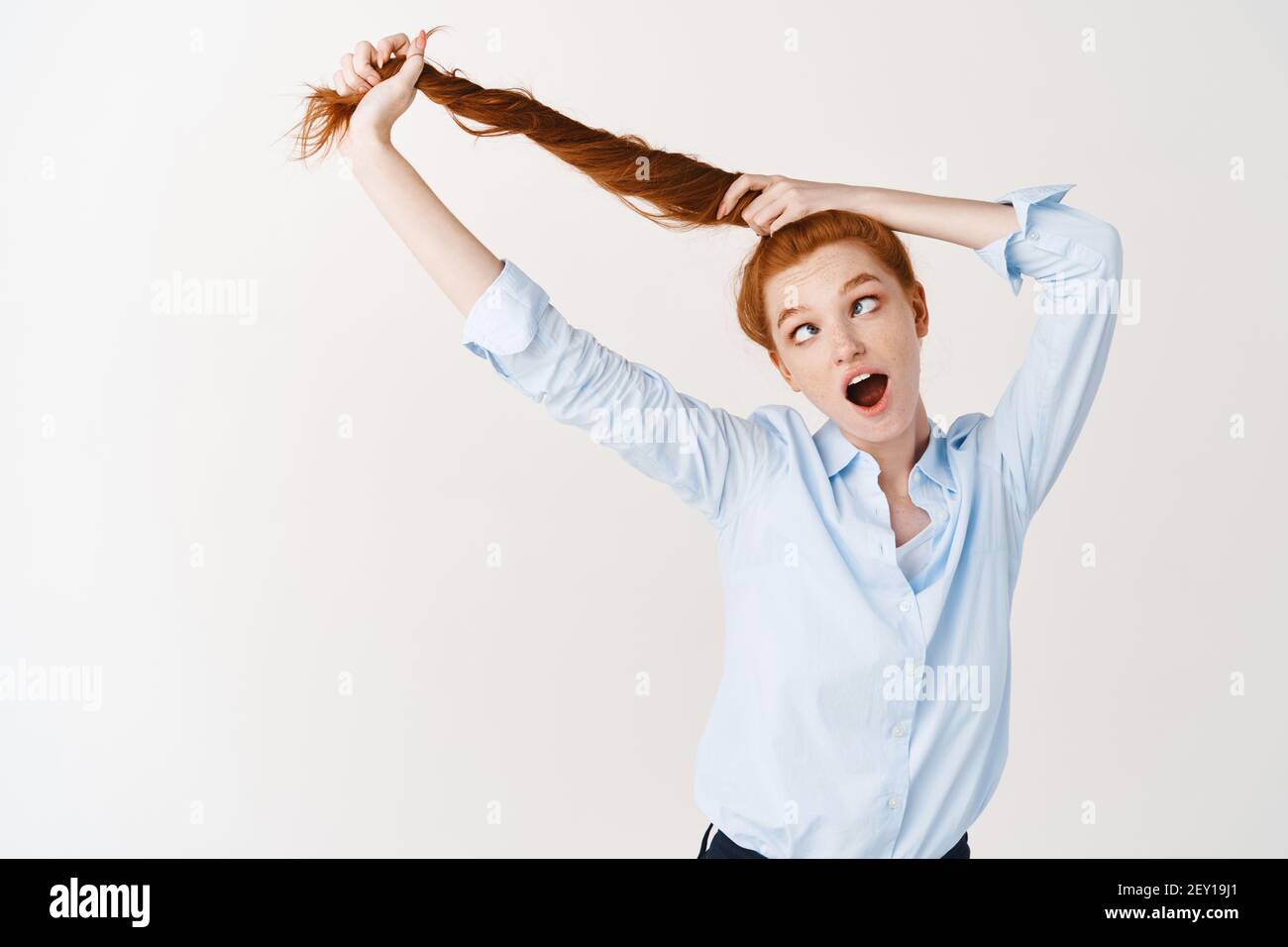 Girl pulling shirt over head hires stock photography and images Alamy
