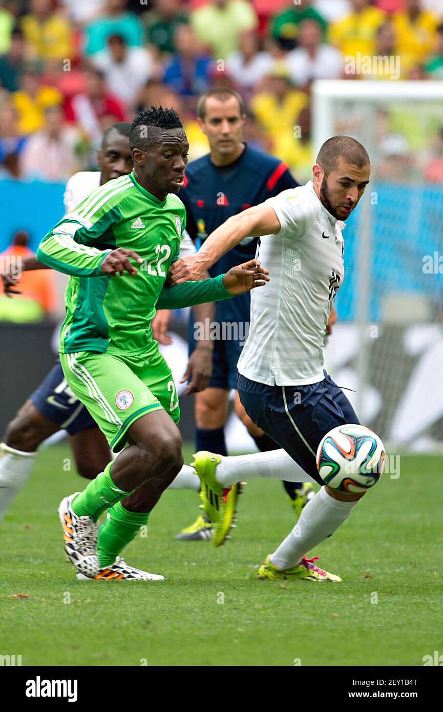 Nigeria's KENNETH OMERUO (L) vies with France's KARIM BENZEMA (R) during the Round of 16 of the 2014 FIFA World Cup soccer match between France and Nigeria, in National Stadium in Brasilia, Brazil, on June 30, 2014. Photo by Jorge Martinez/MEXSPORT/Fotoarena/Sipa USA Stock Photo