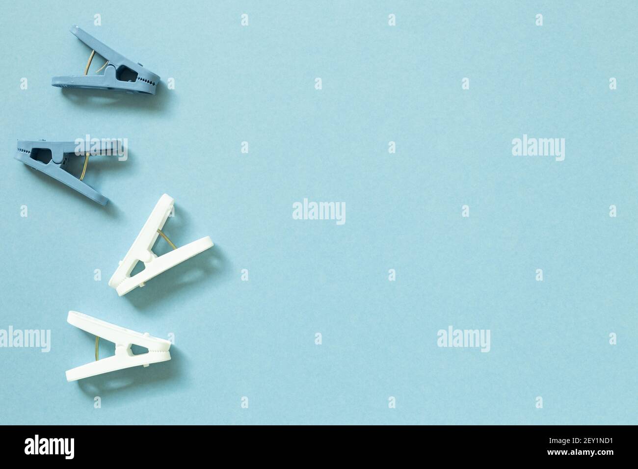 Laundry plastic clothespins on blue background. top view, copy space Stock Photo