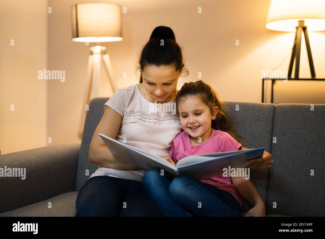 Bedtime Family Story In Evening At Home Stock Photo