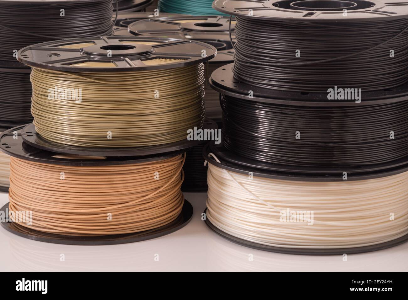 Many PLA and ABS filament spools for 3D printer. Stock Photo