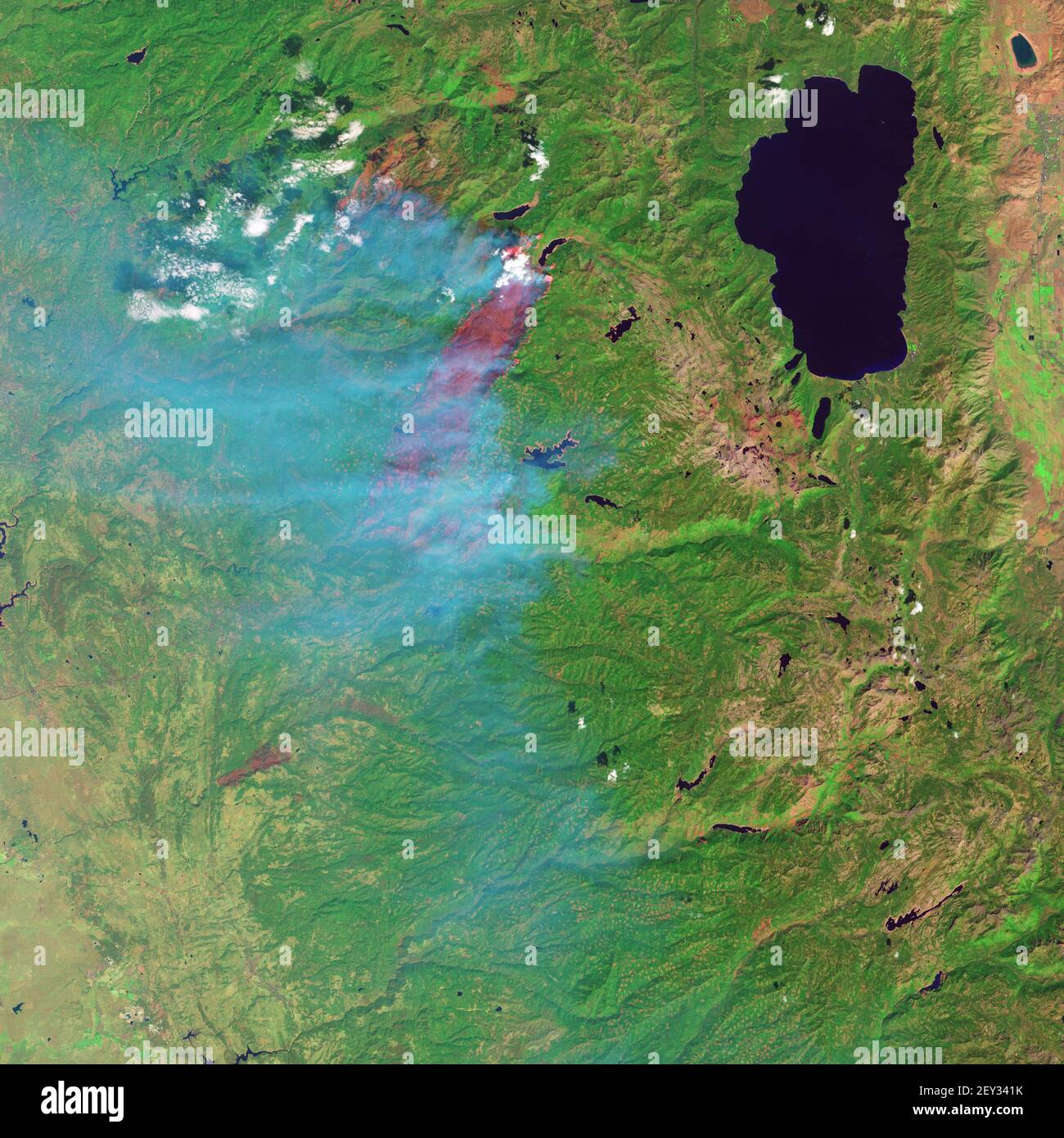 On Sept. 19, 2014, the Operational Land Imager (OLI) on the Landsat 8 satellite captured these images of the King fire in Eldorado National Forest. In the false-color image, burned forest appears red; unaffected forests are green; cleared forest is beige; and smoke is blue. As of Sept. 23, the blaze had charred 36,320 hectares (89,571 acres). (Photo by NASA/Sipa USA) Stock Photo