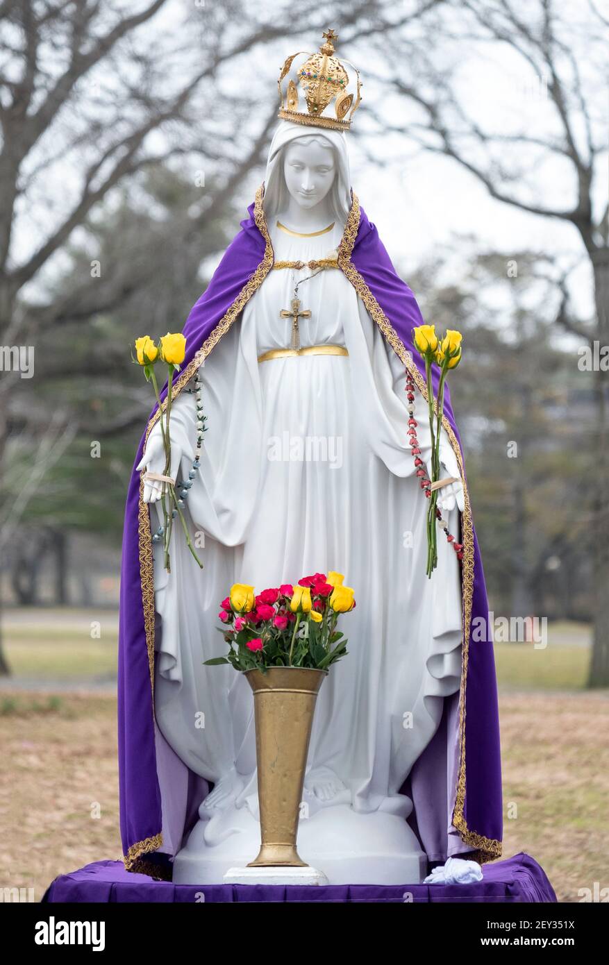 A statue of the Virgin Mary with a pupple cape signifying lent. At an outdoor prayer service in Flushing Meadows Corona Park in Queens, New York City. Stock Photo