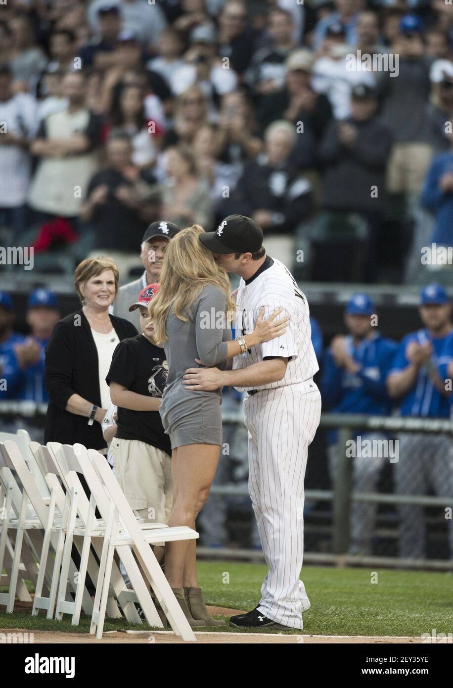 Chicago White Sox designated hitter Paul Konerko (14) gives his wife,  Jennifer, a kiss during his retirement ceremony as the team plays host to  the Kansas City Royals at U.S. Cellular Field