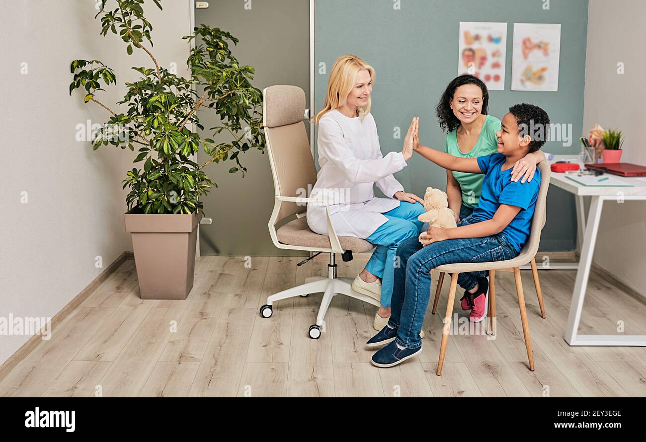 Kids psychologist works with African American family in a doctor's office. Children's mental health Stock Photo