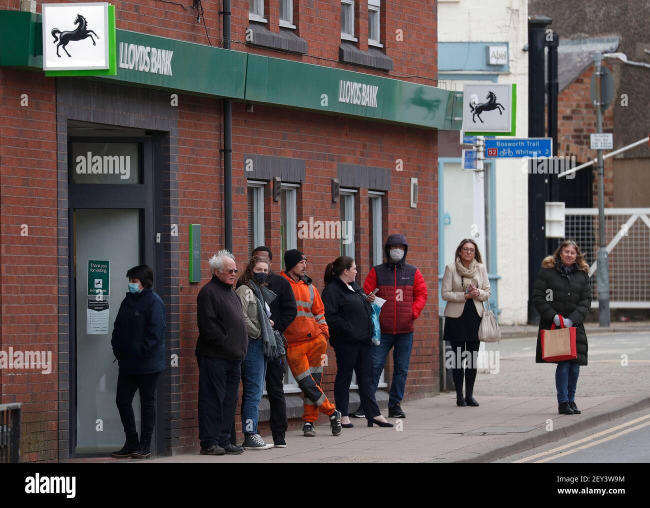 Coalville, Leicestershire, UK. 5th March 2021. Customers queue outside a Lloyds Bank. North West Leicestershire has the highest coronavirus rate in England according to the latest Public Health England figures. Credit Darren Staples/Alamy Live News. Stock Photo