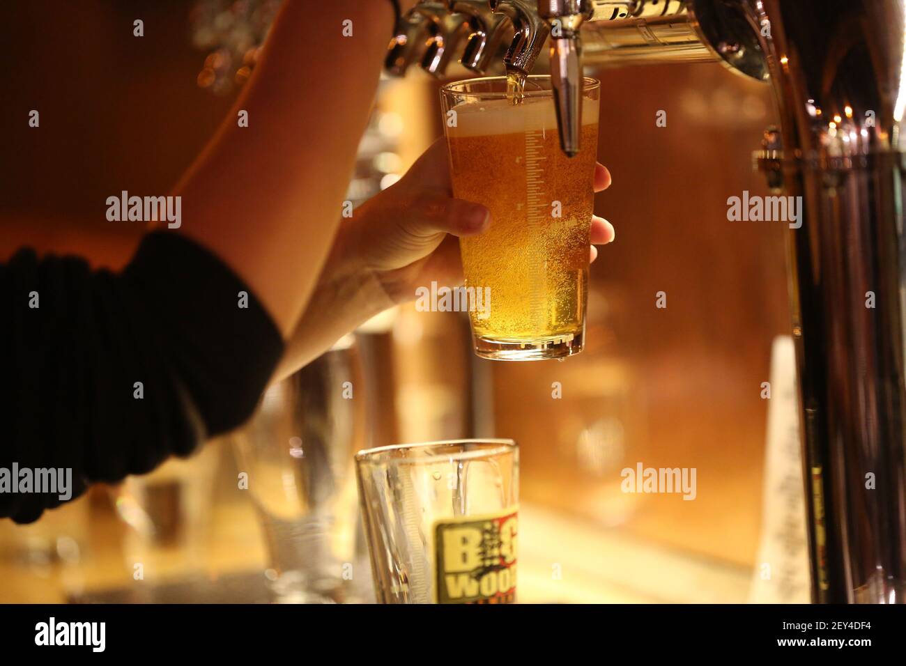 Veronica Larson pours a beer for a customer at Big Wood Brewery in