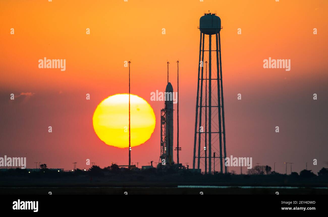 The Orbital Sciences Corporation Antares rocket, with the Cygnus spacecraft onboard, is seen on launch Pad-0A during sunrise, Sunday, Oct. 26, 2014, at NASA's Wallops Flight Facility in Virginia. The Antares will launch with the Cygnus spacecraft filled with over 5,000 pounds of supplies for the International Space Station, including science experiments, experiment hardware, spare parts, and crew provisions. The Orbital-3 mission is Orbital Sciences' third contracted cargo delivery flight to the space station for NASA. Launch is scheduled for Monday, Oct. 27 at 6:45 p.m. EDT. (Photo by NASA/Si Stock Photo