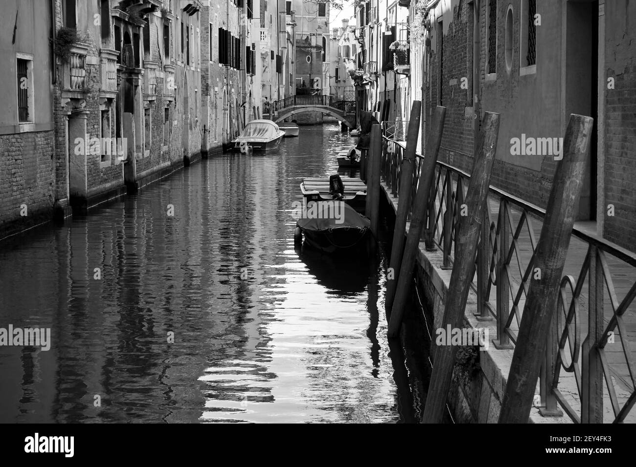 Perspective of a side canal in Venice, Italy. Black and white photography, venetian view Stock Photo