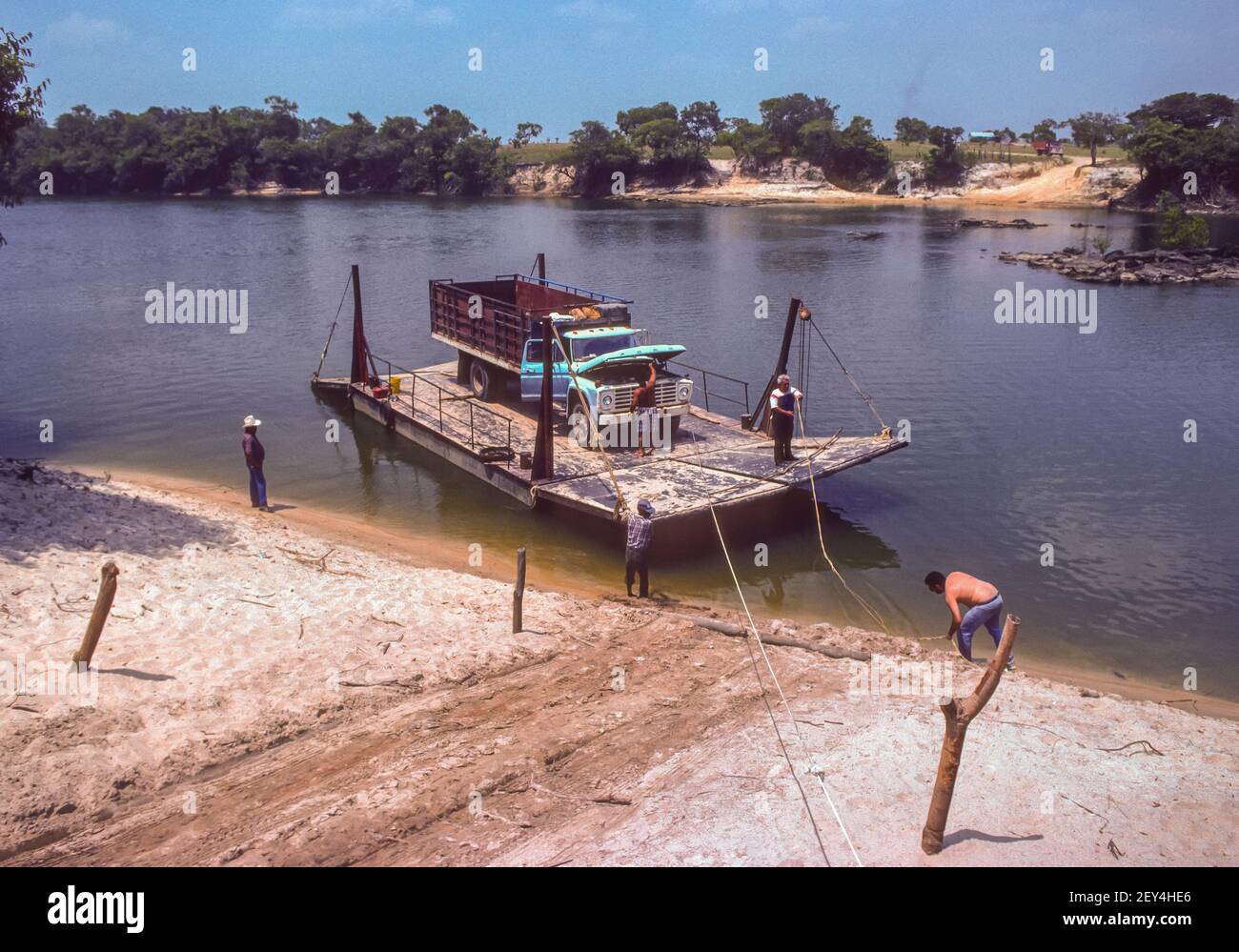 APURE STATE, VENEZUELA - Truck on river ferry pulled by hand across Cano La Pica River. Stock Photo
