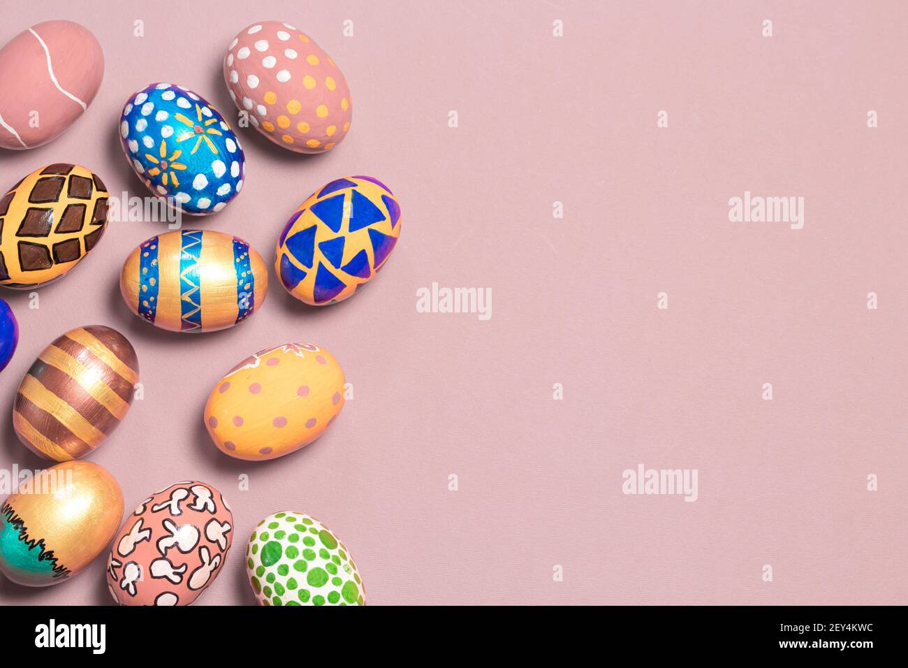 A gentle festive banner colored Easter eggs on a light pink background with room for text to copy the space. Options for coloring eggs for Easter Stock Photo