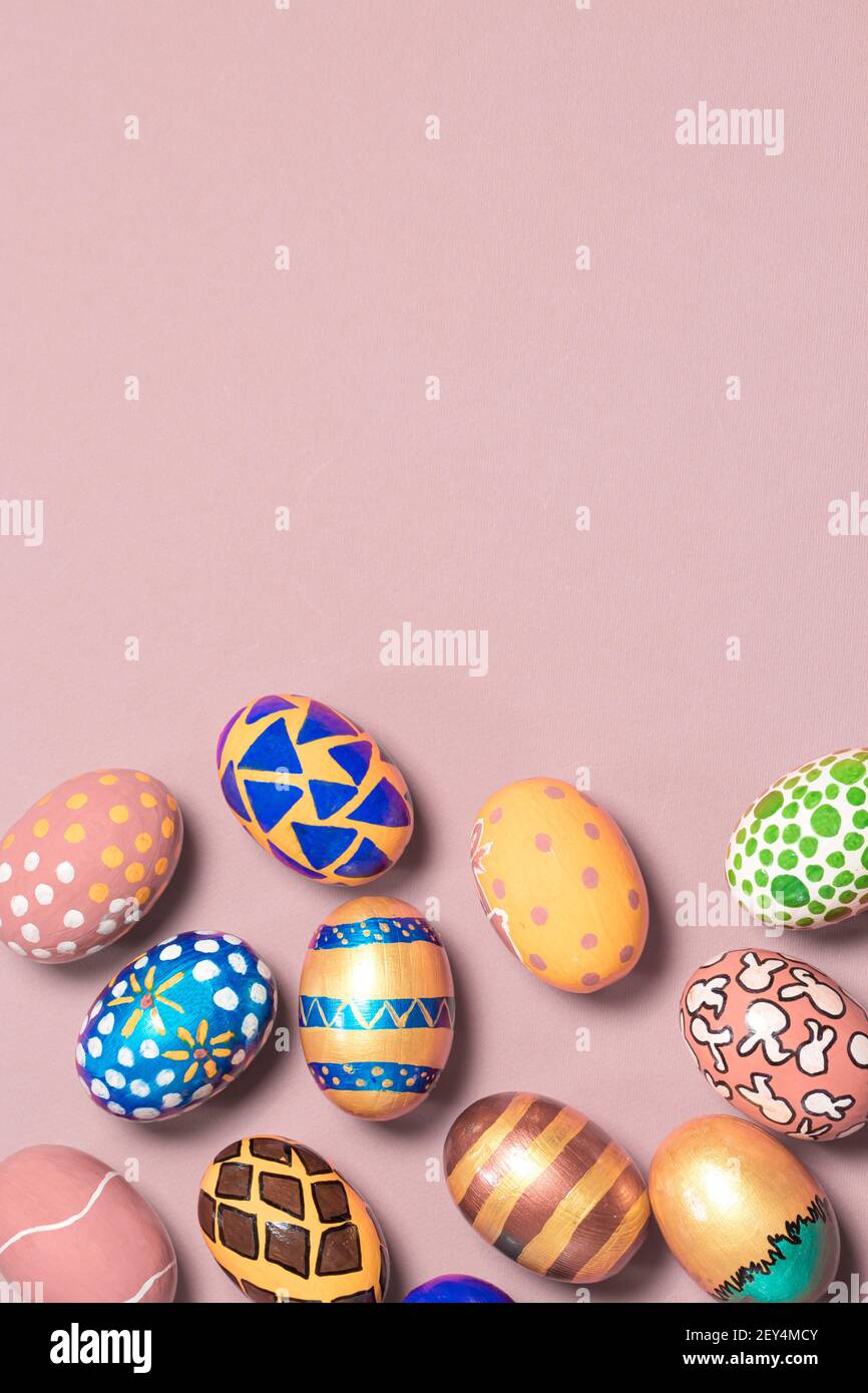 A gentle festive banner colored Easter eggs on a light pink background with room for text to copy the space. Options for coloring eggs for Easter Stock Photo