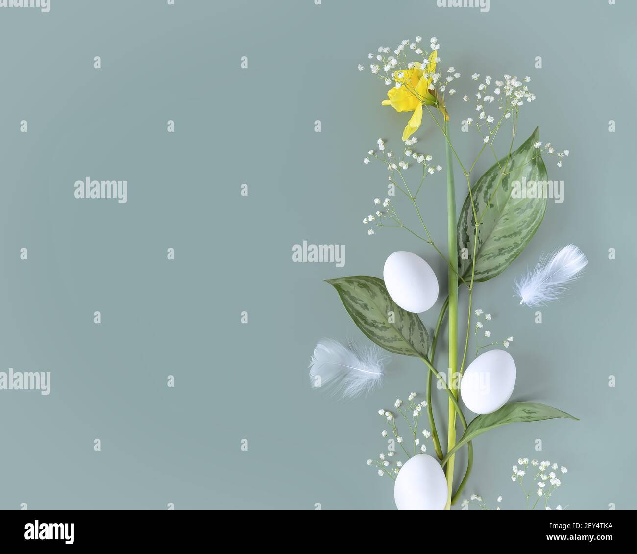 Horizontal spring composition with flowers and white eggs on a blue ...