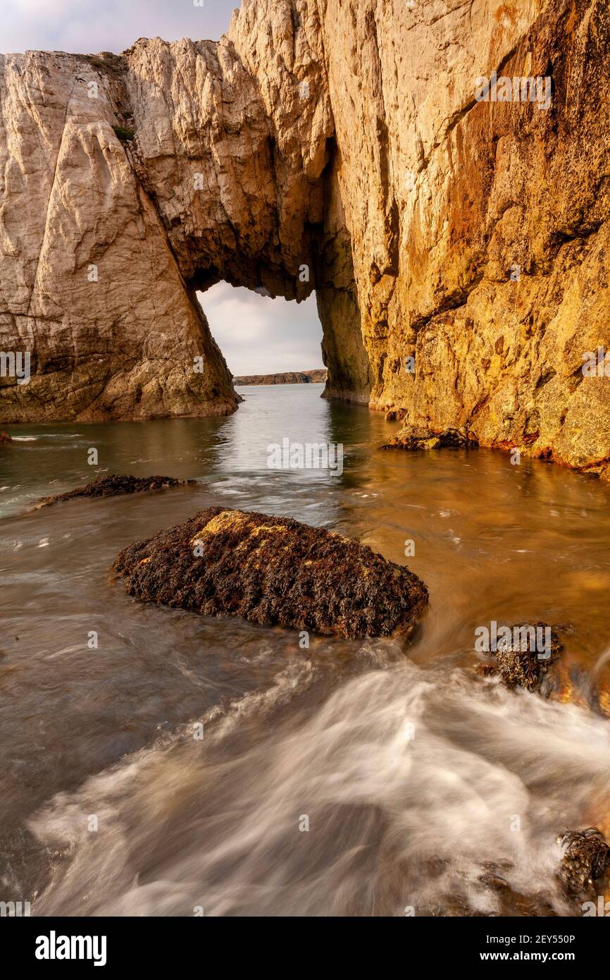 Bwa Gwyn sea arch near Rhoscolyn, Anglesey, North Wales Stock Photo