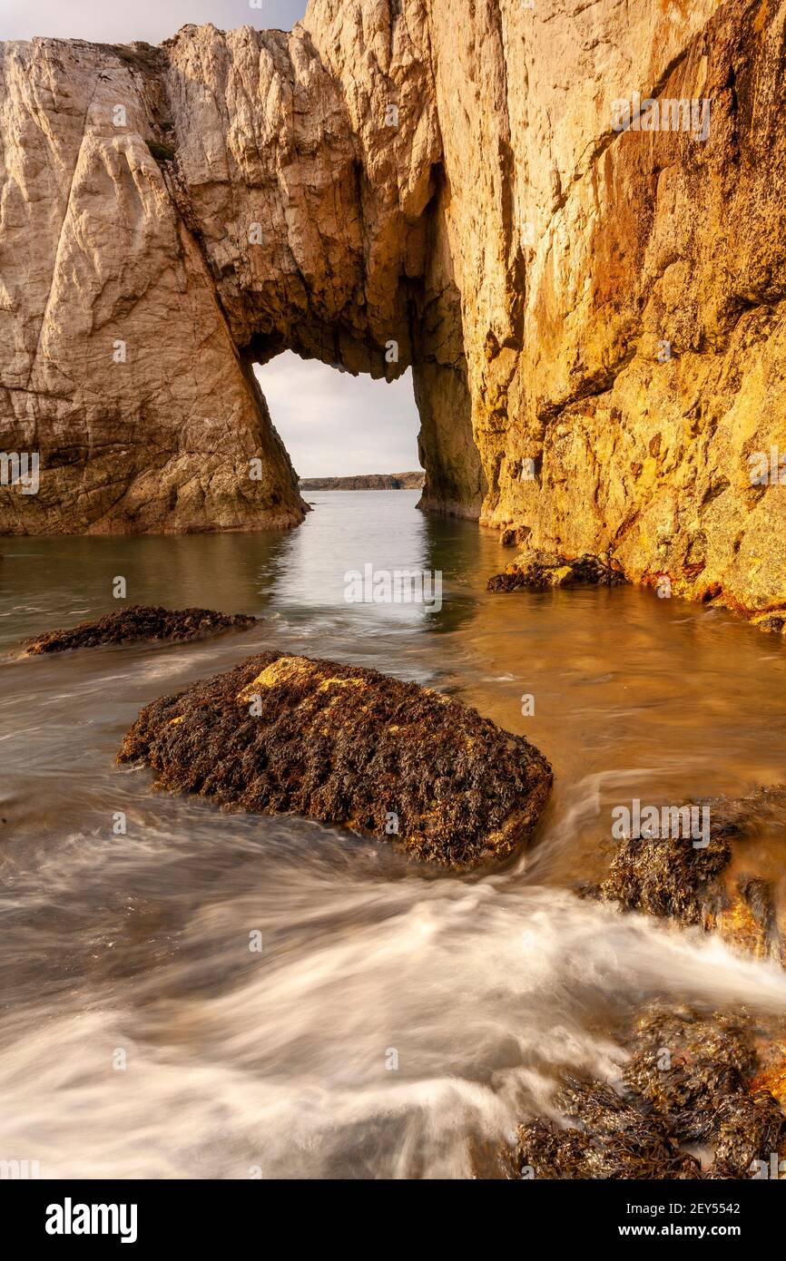 Bwa Gwyn sea arch near Rhoscolyn, Anglesey, North Wales Stock Photo