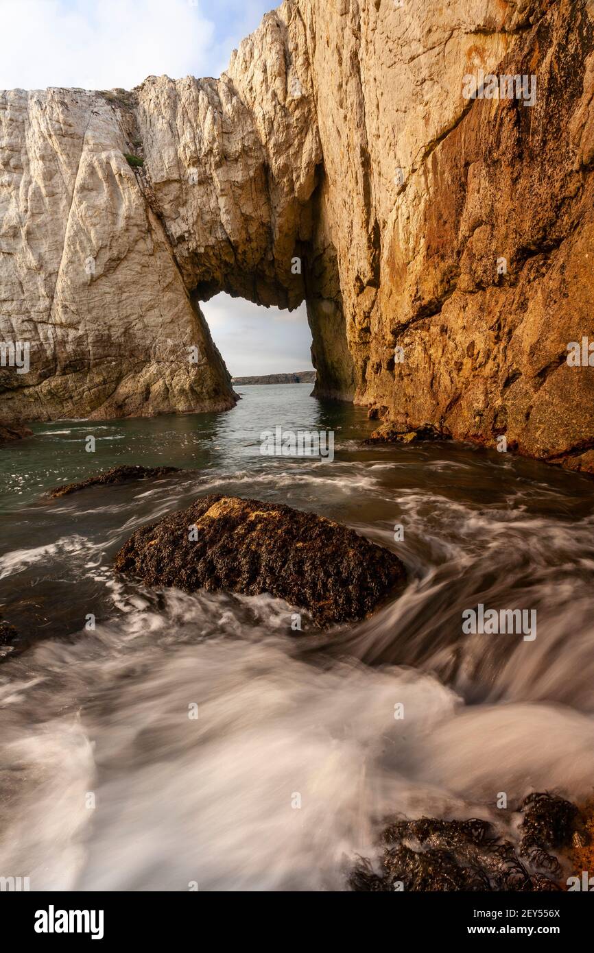 Bwa Gwyn sea arch near Rhoscolyn, Anglesey, North Wales Stock Photo