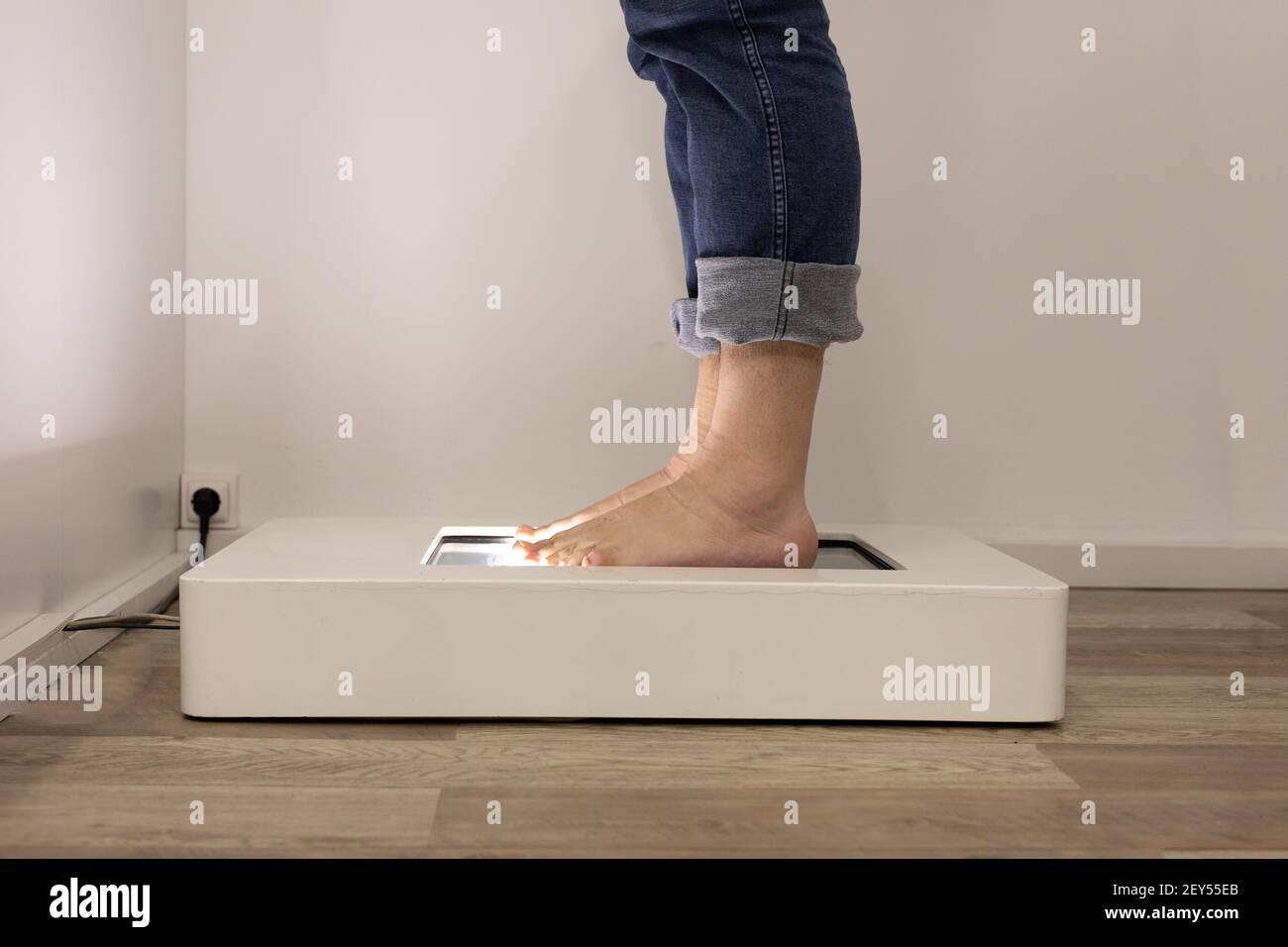 Foot scanning to determine exact size and feet form. Man using the electric device in a shoe store. Stock Photo