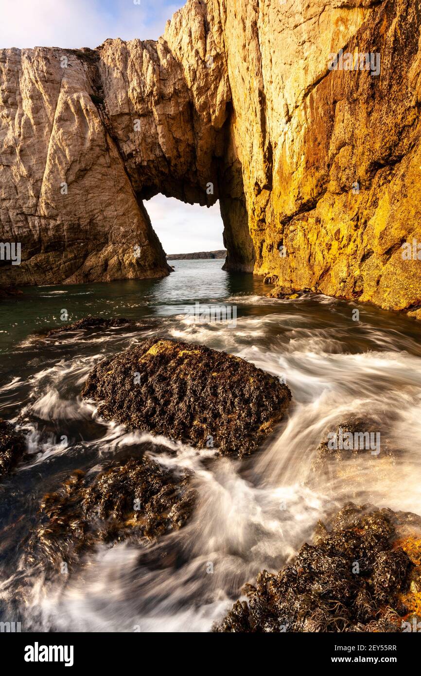 Bwa Gwyn sea arch near Rhoscolyn, Anglesey, North Wales Stock Photo