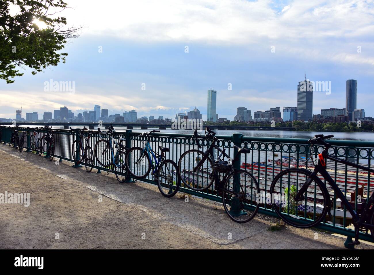 View over the River Charles with the Boston skyline in the background and bicycles in the foreground alon the railing. Stock Photo