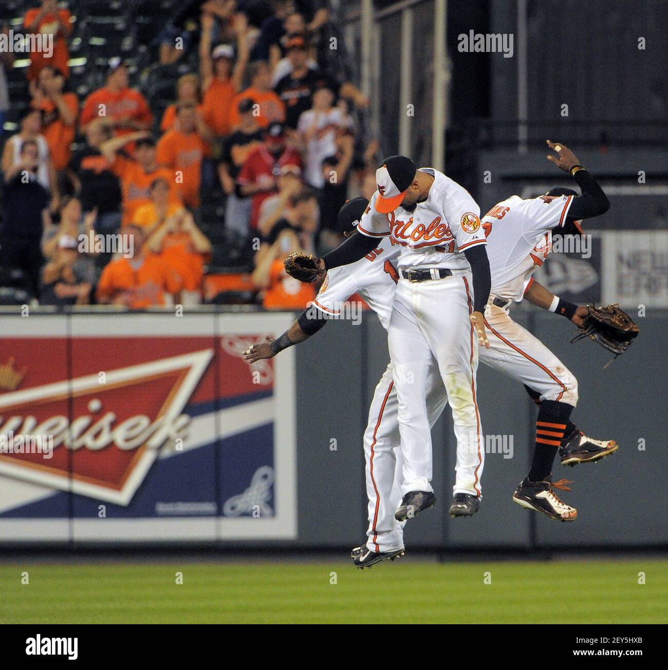 Baltimore Orioles outfielders, from left to right, Felix Pie, Nick Markakis  and Adam Jones celebrate after defeating the Texas Rangers 5-0 in the first  baseball game of a doubleheader on Saturday, April