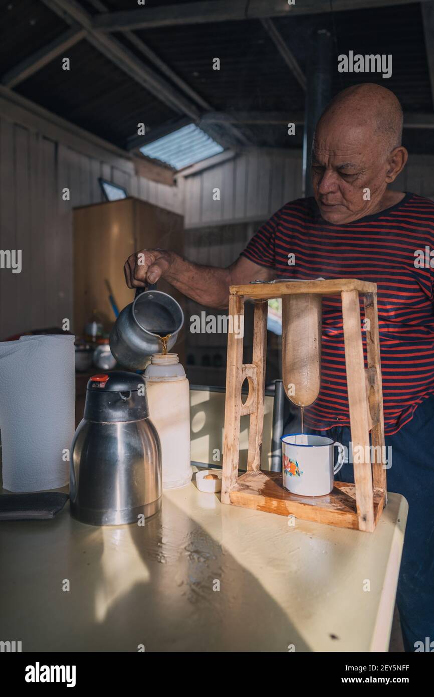 Senior man making coffee in a traditional way Stock Photo