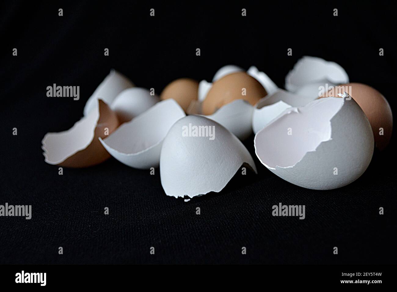 coloured eggshells on black background Stock Photo