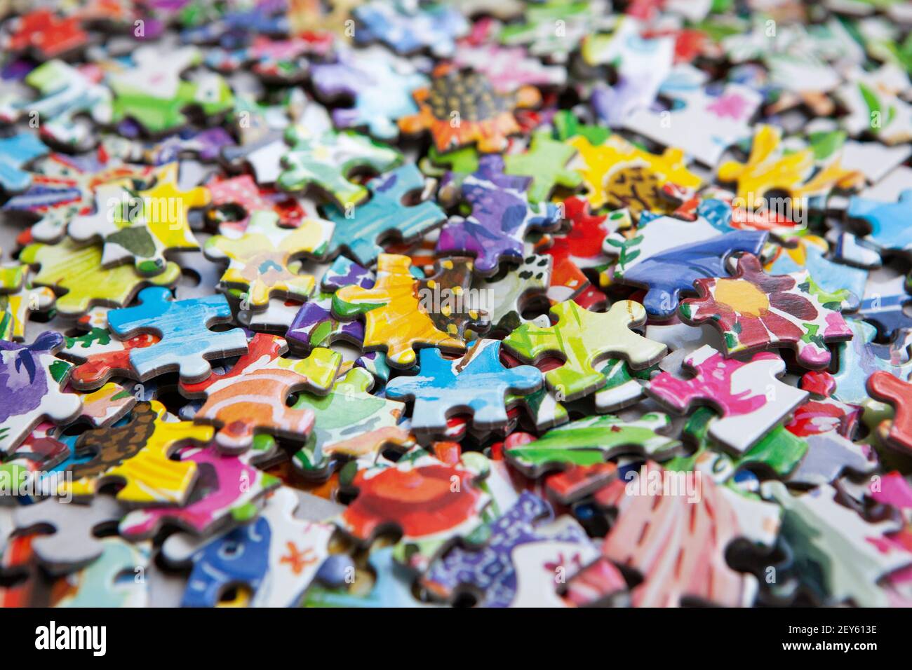 London, UK, 5 March 2021: a box of colourful jigsaw pieces. During the pandemic lockdowns sales of jigsaws have risen as people look for ways to pass Stock Photo
