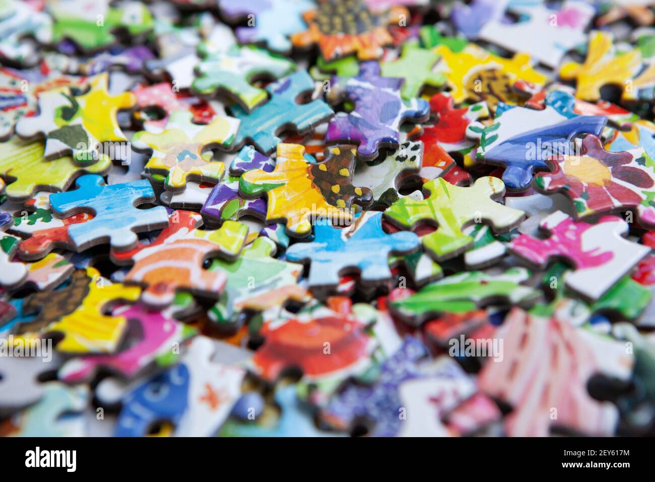 London, UK, 5 March 2021: a box of colourful jigsaw pieces. During the pandemic lockdowns sales of jigsaws have risen as people look for ways to pass Stock Photo