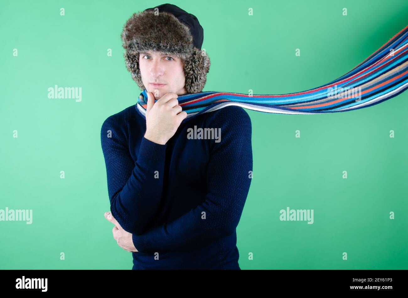 Young attractive guy is drinking a hot drink. Stock Photo