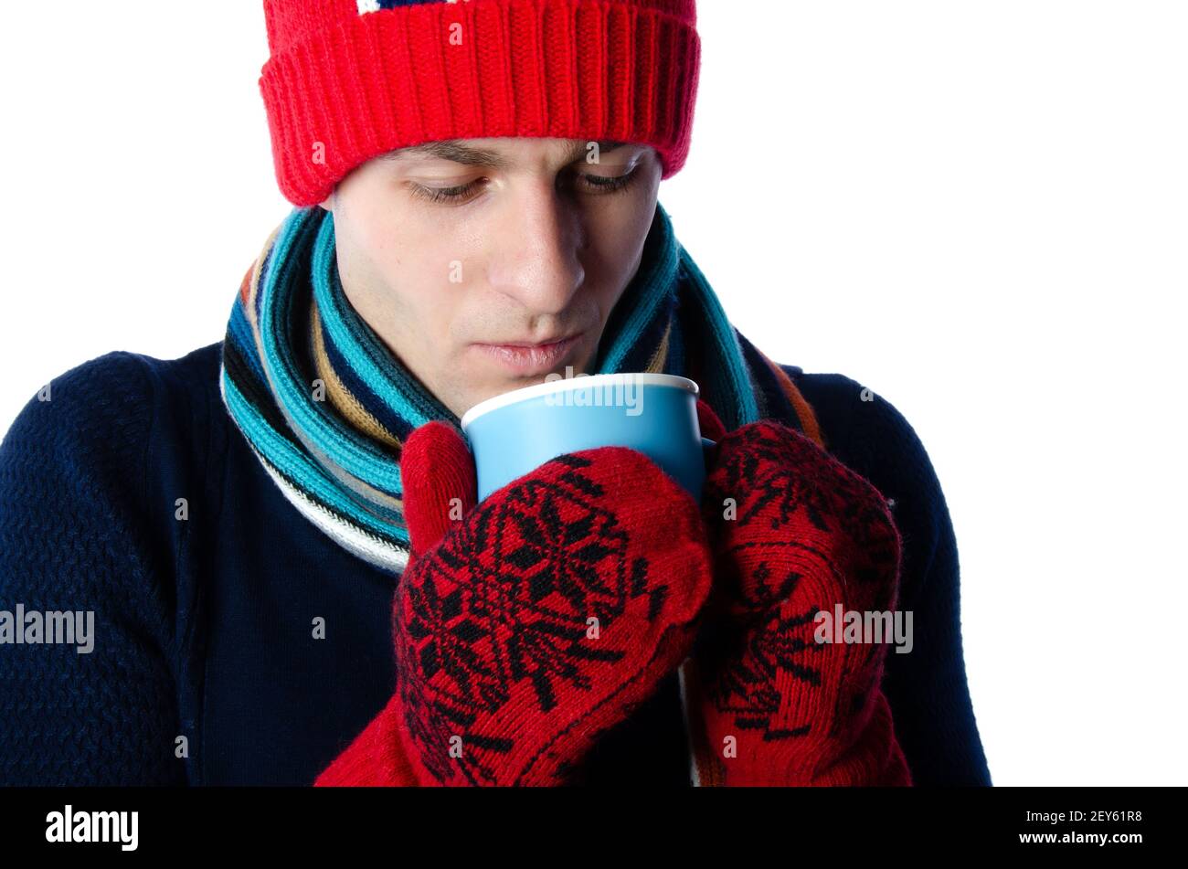 Young attractive guy is drinking a hot drink. Stock Photo