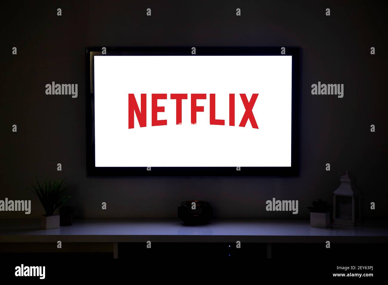 ROSARIO, ARGENTINA - MARCH 4, 2021: Netflix logo on the screen of LCD Smart TV in the middle of a living room of a family home. Stock Photo