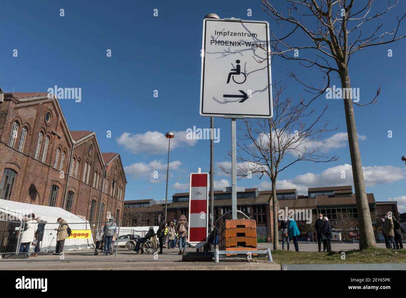 Dortmund, NRW, Germany, 05th Mar 2021. An orderly queue of people with appointments has formed outside the centre. Signage and directions to Impfzentrum Phoenix-West. Phoenix West, a former blast furnace and industrial site now housing culture and music venues is currently Dortmund's largest and busiest vaccination centre. The vaccination campaign in Germany is picking up momentum. Earlier this week, The German health ministry and vaccination commission STIKO cleared Astra Zeneca's vaccine for use in the over 65 age group. In addition, GP practices can start administering vaccinations soon. A Stock Photo
