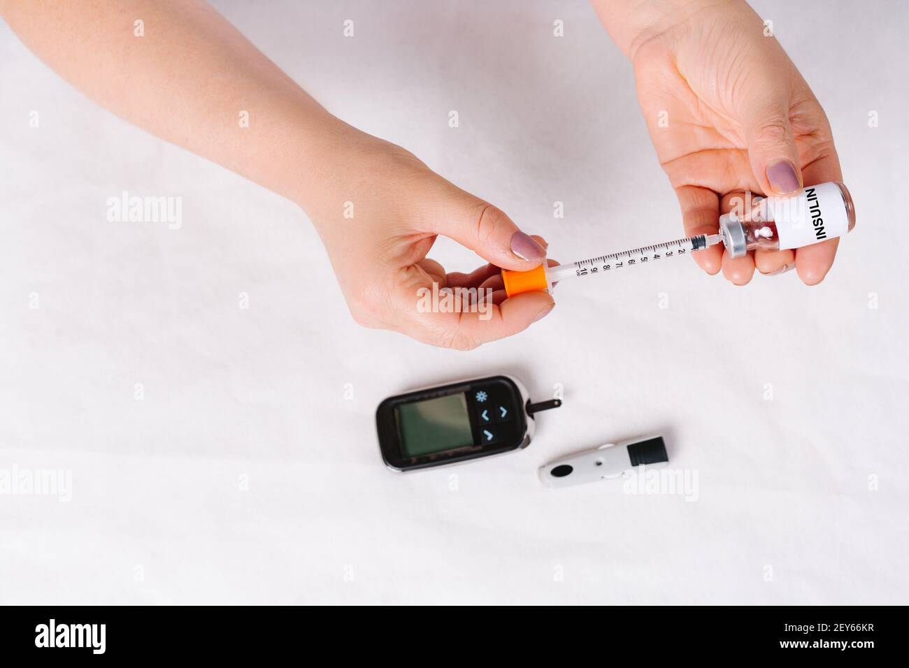 Insulin syringe for administering insulin to diabetic patients on white background. Diabetes