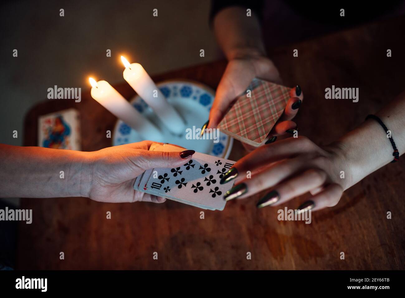 choose a card from the hands of a fortune teller. a woman tells fortunes during a magical ritual. belief in mysticism Stock Photo