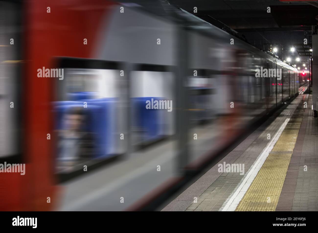 train moves along the platform at night Stock Photo - Alamy