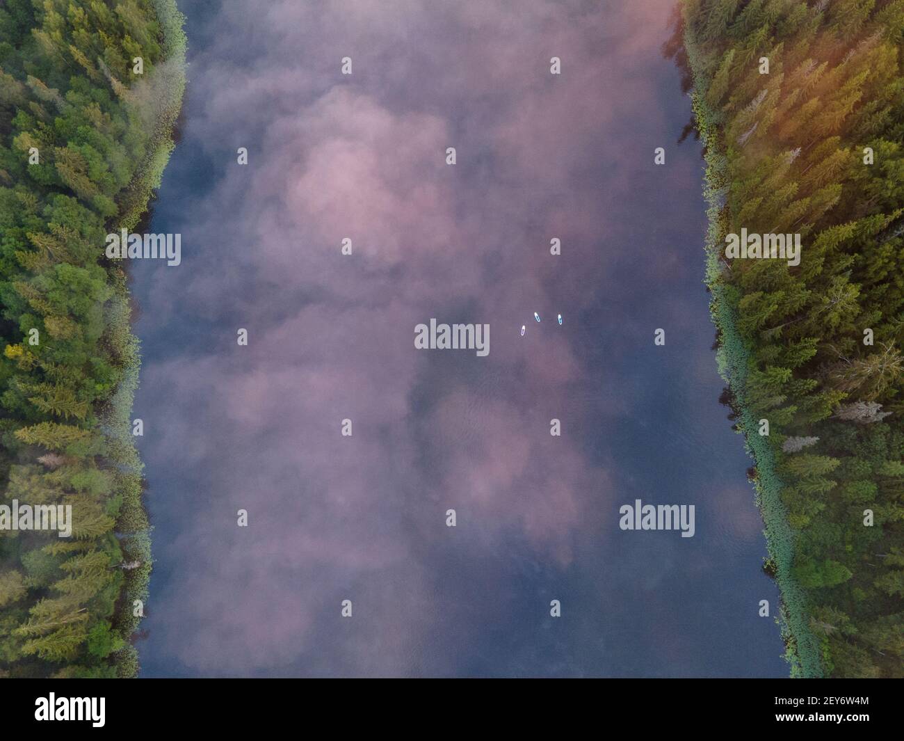 An aerial view of morning fog over the paddleboards in a lake ...