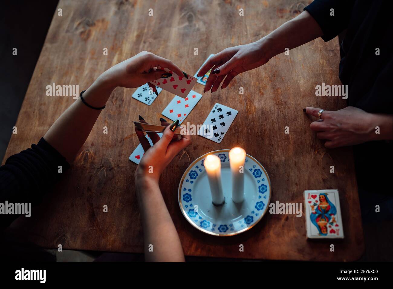 choose a card from the hands of a fortune teller. a woman tells fortunes during a magical ritual. belief in mysticism Stock Photo
