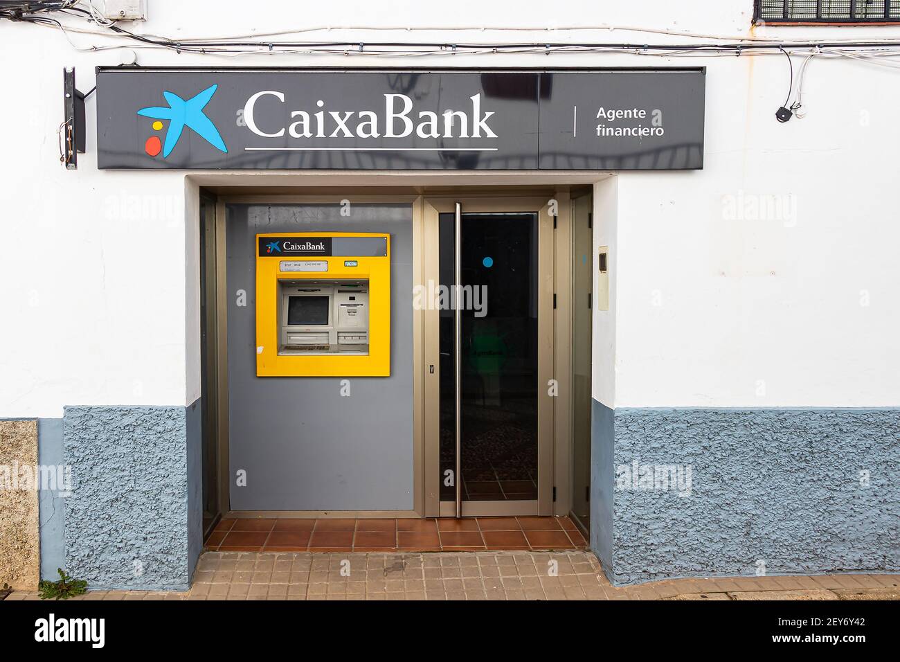 Huelva, Spain - March 1, 2021: ATM machine of Caixabank bank in Santa Ana La Real village, Huelva, Andalusia, Spain Stock Photo
